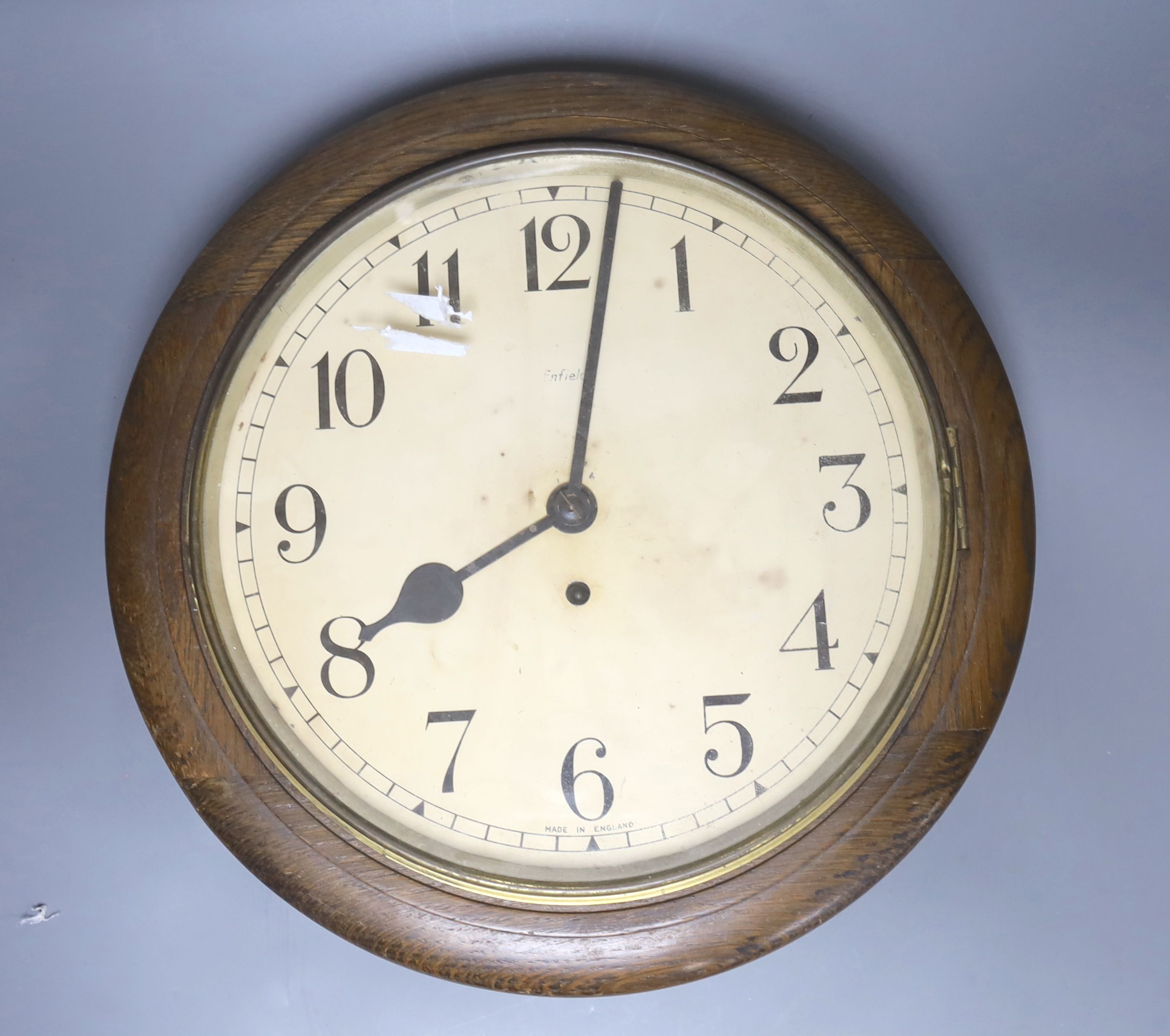 An oak cased wall clock, with black Arabic numerals, by Enfield, diameter 39cm